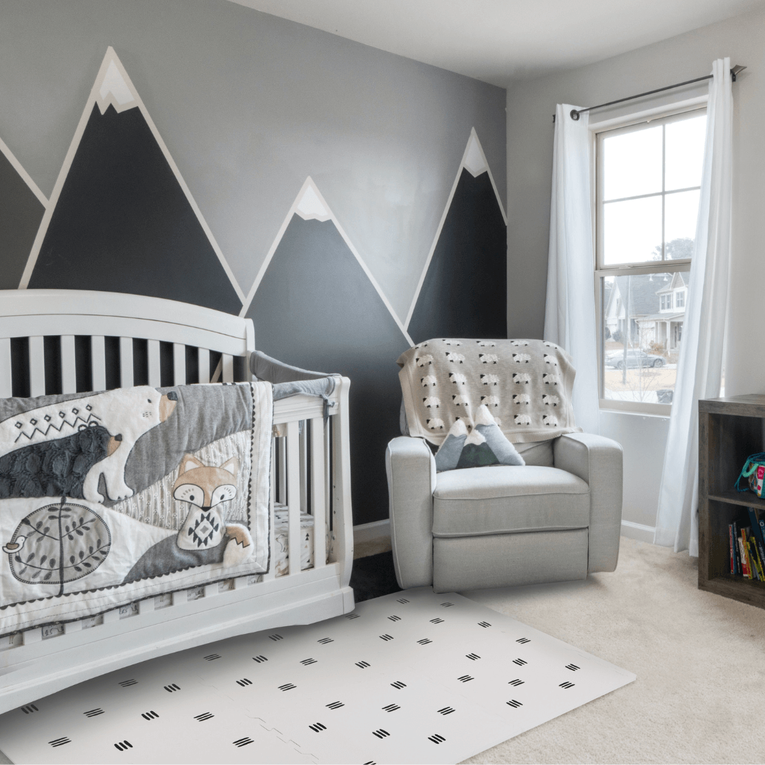 The White with black stripes play mat, set up in a child’s room with matching decor.