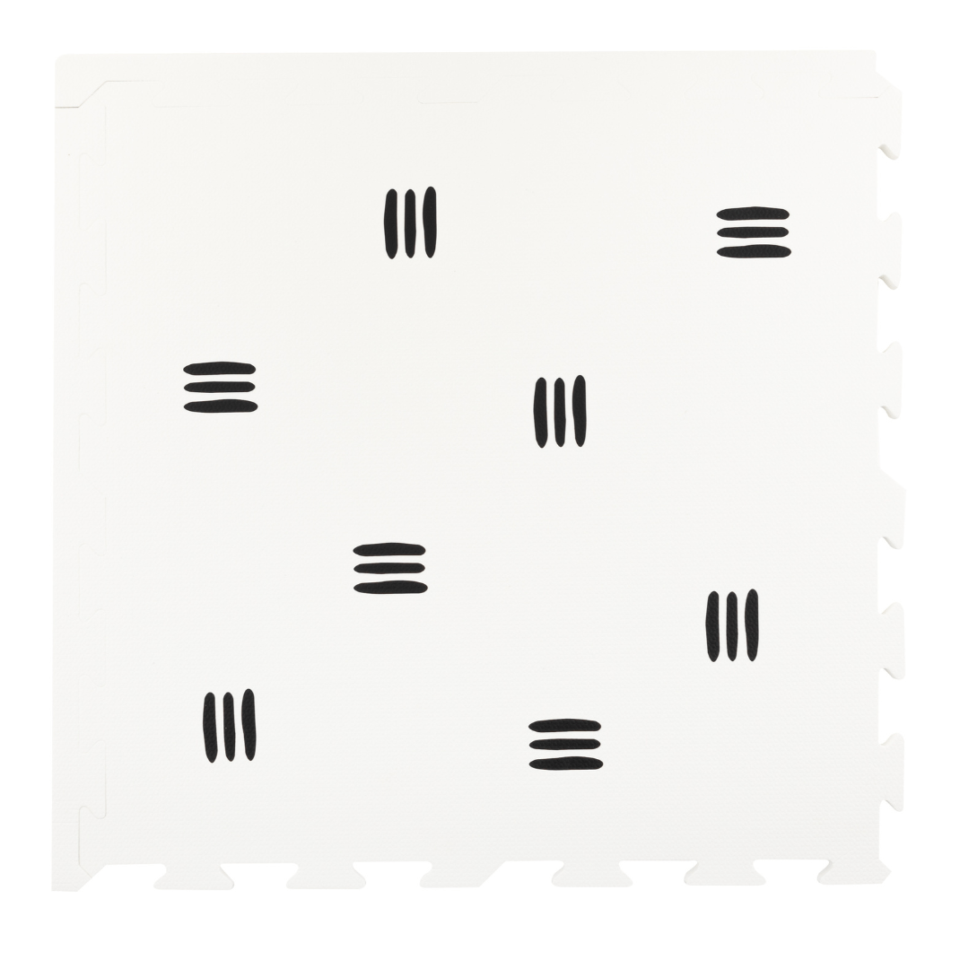 a single tile from the White with black stripes play mat from Maxie and Moo, which features a sleek and modern monochrome design of white mat with 3 black stripes. The unique and timeless design of this play mat adds a touch of class and sophistication to any play area or nursery. 