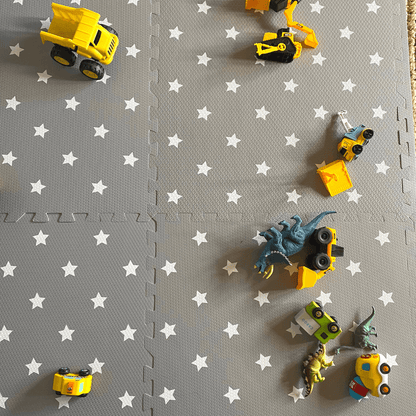 Image of the Grey with white stars play mat, set up in a play space in the home. 