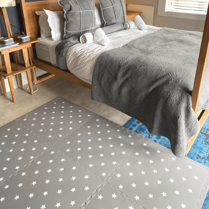 Grey with white stars play mat, set up in a bedroom play space in the home.