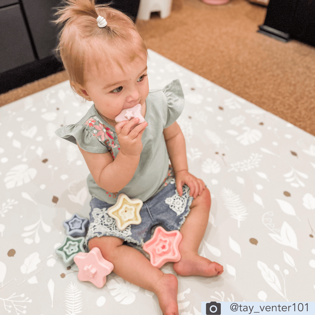 child playing on the Metallic Garden padded playmat from Maxi and Moo playmats