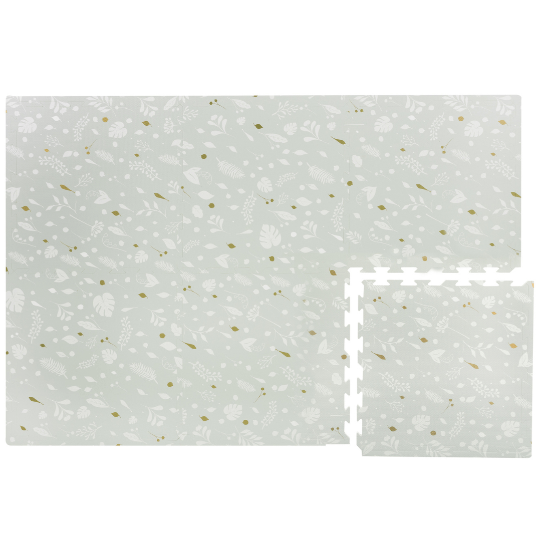 Image of a Metallic Garden Play Mat showcasing its modular design, with one tile disconnected from the full mat. The play mat features a charming design of white leaves on a stylish grey background with pops of metallic gold. This mat will bring a touch of elegance and playfulness to your child's play area or nursery.